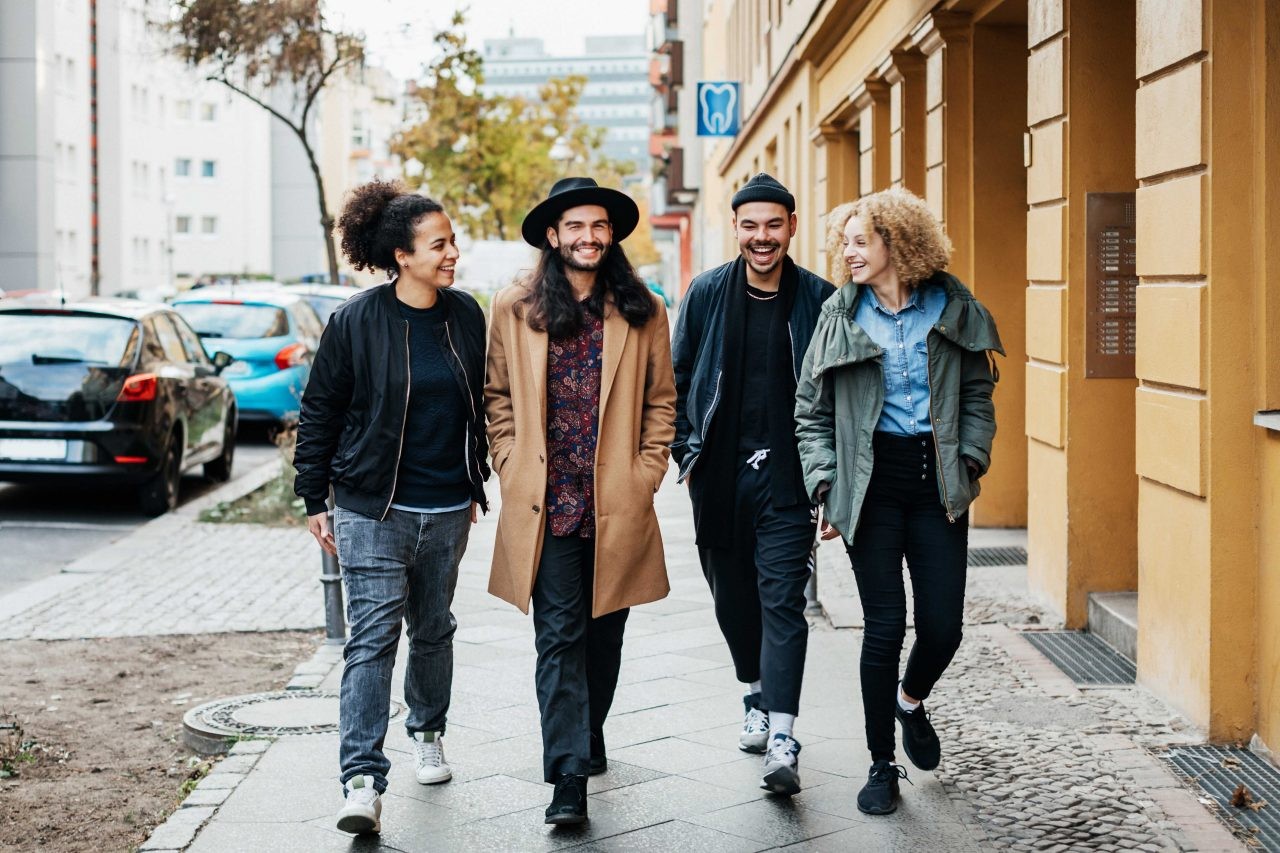 Group of four people walking down the street